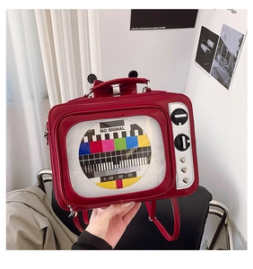 Detailed view of red retro television backpack with No Signal screen and silver knobs