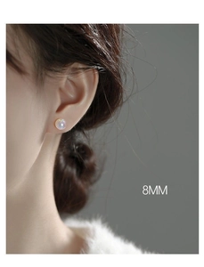 Detailed model shot of 8mm round pearl earrings with iridescent mermaid luster finish