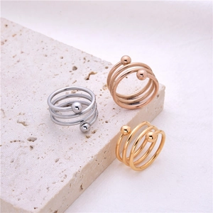 Three-layer spiral stainless steel rings in silver, gold, and rose gold with ball ends