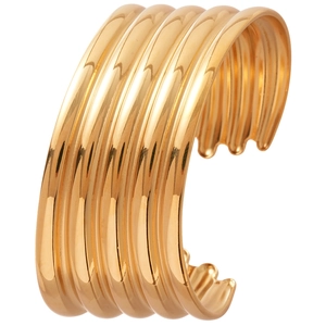 Golden multilayer ribbed open cuff bracelet with irregular metallic texture in 45-degree view