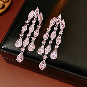 Elegant long silver drop earrings featuring pink zircon tassels on a black leather box