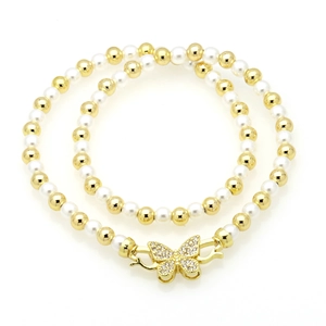 Elegant natural pearl necklace with gold beads and a sparkling rhinestone butterfly clasp