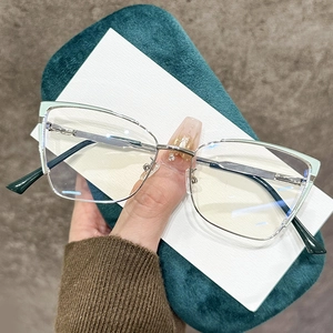 Silver cat-eye metal frame glasses with green accents and stylish two-tone design