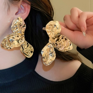 Dramatic gold metallic petal earrings with hammered texture and wrinkled flower design