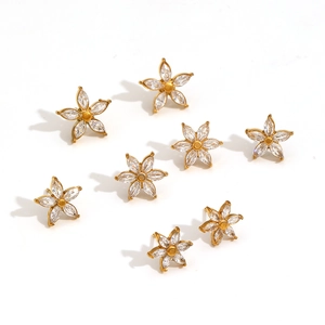 Detailed close-up of 18k gold flower earrings with sparkling marquise cut zircon stones
