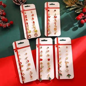 Macro view of Christmas earring set with Santa, reindeer and snowflake stud details
