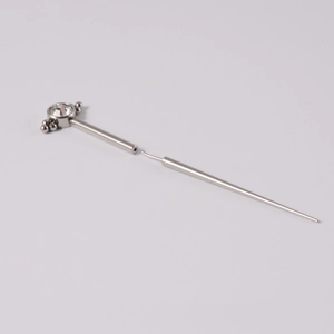 Macro shot of 316L stainless steel body piercing needle with clear gemstone and bead detail