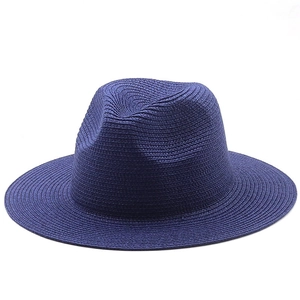 Detailed texture of navy blue woven straw sun hat with classic wide brim fedora style