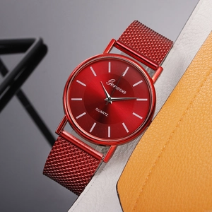 Close-up of red mesh band quartz watch with sunray dial and minimalist index