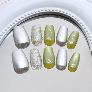 Translucent green cat eye press-on nails with silver glitter and metallic finish