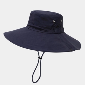 Detail of navy sun hat featuring large brim, breathable air vents, and chin strap cord