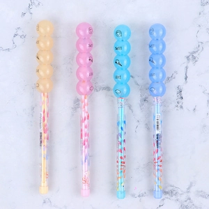 Detail of colorful stackable pencils with sweet bubble toppers on marble background