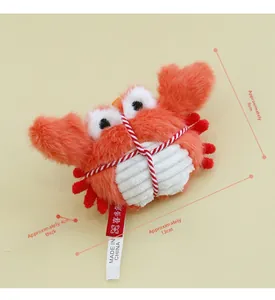Detail showing plush crab catnip toy with white striped fabric and 13cm size mark