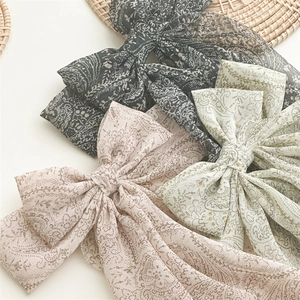Three oversized Paisley pattern chiffon bow hair clips in black pink and green colors
