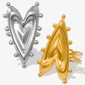 Detailed view of polished heart-shaped rings with metallic bead texture and V-shape design