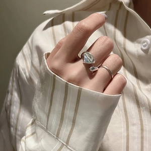 Irregular lava style S925 sterling silver ring set worn by a model in casual setting