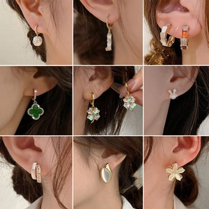 Collage of chic gold earrings with pearls and clover charms on model's ear