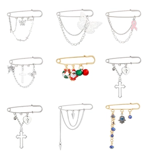 Nine punk style brooches with butterfly heart and cross charms in silver and gold
