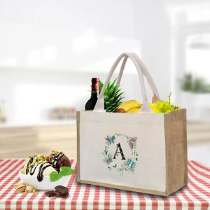 Linen canvas tote bag with floral letter A print shown in a lifestyle kitchen setting