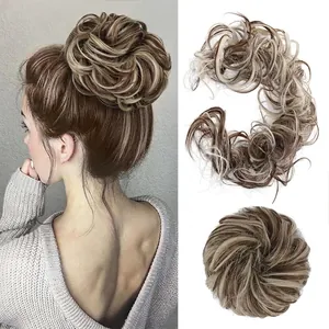 Detail showing a messy bun hair piece in light brown mixed with blonde highlights