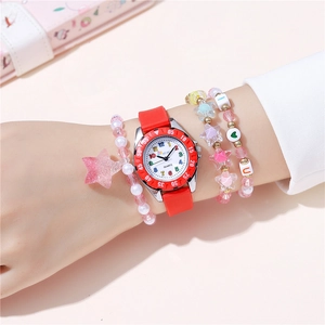 Detail of pink silicone watch and matching beaded bracelets on wrist for girls