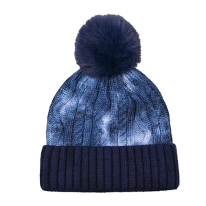 Detailed knit texture of tie-dye beanie featuring a fluffy pom-pom and thick ribbed cuff