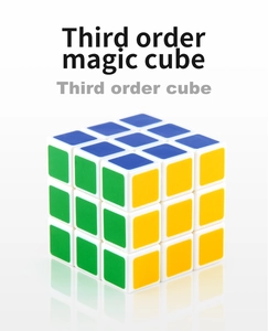 Macro view of a classic white frame 3x3 speed cube with green and yellow panels