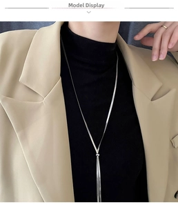 Detail of silver long snake chain necklace with adjustable slider on a model