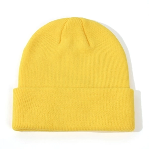 Close-up of vibrant yellow ribbed knit beanie showing soft wool texture and folded cuff