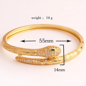 Detailed view of gold snake-shaped bangle featuring cubic zirconia settings and dimensions