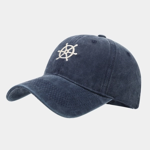 Close-up of anchor wheel embroidery on navy blue washed cotton baseball cap