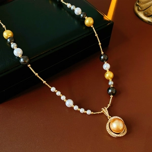 Detailed view of luxury pearl necklace with gold chain and zircon pendant on leather background