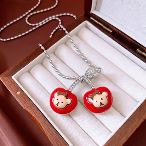 Sweet red enamel cherry pendant necklace with bear detail and sparkling rhinestones