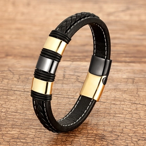 Fashionable black braided leather bracelet with gold and silver metal charms and magnetic clasp