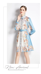 Detailed view of the blue and white floral long-sleeve dress with matching belt