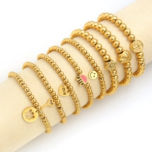 Set of eight 18K gold plated stainless steel beaded bracelets with various charms