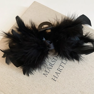Detailed view of the soft black feathers and silk bow knot on this vintage hair claw clip