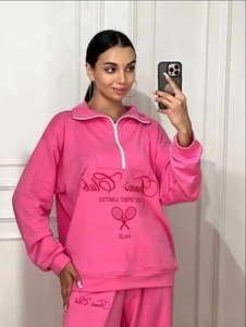 Pink two-piece tracksuit set with half-zip sweatshirt and high-waisted jogging pants