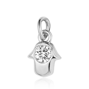 Macro shot of silver Hamsa Hand pendant with a central round clear zircon and soft reflection