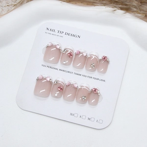 Handmade press-on nails with pink heart rhinestones and pearls in a French sweet style