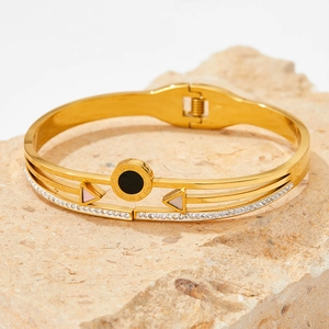 Gold stainless steel bangle with Roman numeral disc and pave crystals on stone