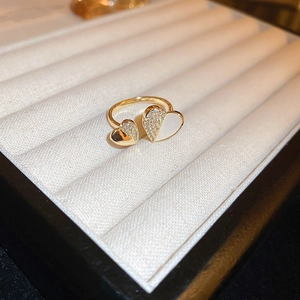 Macro shot of gold-plated double heart open ring featuring pave zircon and shell inlay
