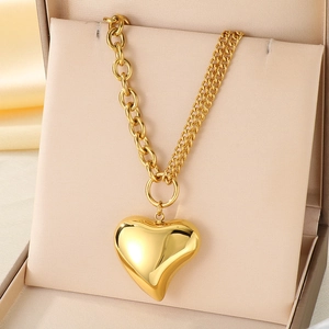 18K gold hollow heart pendant necklace with mixed link chain design on silk pad