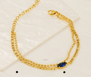 Detail of double-layer stainless steel gold bracelet with blue marquise zircon stone