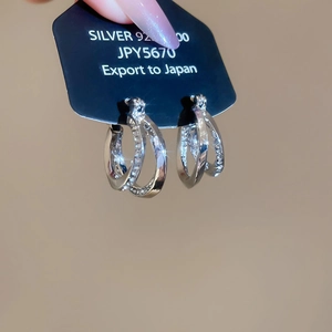 Detailed close-up of double layer silver 925 earrings with shiny pavé diamond circles