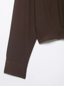 Detail of dark brown twill fabric texture and reinforced stitching on short shoulder strap shirt