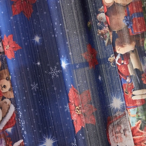 Detailed close-up of Christmas curtain fabric with bear and flower patterns