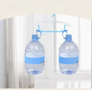 Detail of durable telescopic baby clothes hanger showing heavy load capacity with water jugs