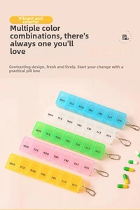 Detail of 7-compartment weekly pill organizers in five colors with metal keychain clips
