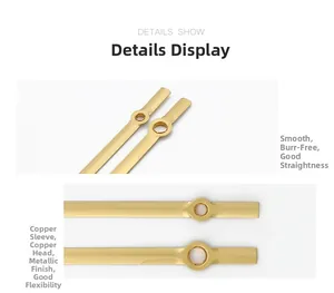 Close-up of golden metal clock hands with copper bushings showing high precision finish